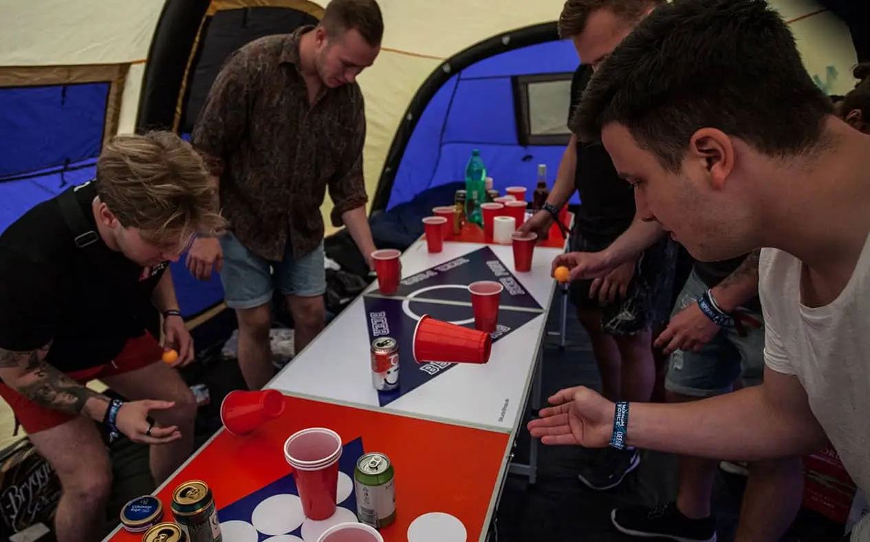 Coretours campers playing beer pong at Coretours camp